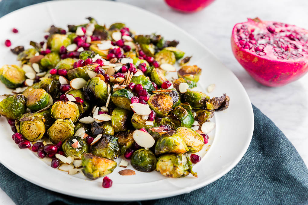Looking for a 30-minute side dish easy enough for a weeknight meal, yet fancy enough for entertaining guests? This Pomegranate Roasted Brussels Sprouts recipe is the seasonal side dish you need! Sweet and tart, this simple side dish will enhance any meal!