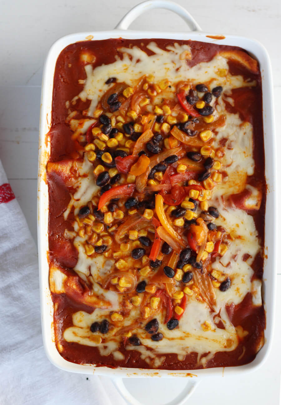 This lightened up version of Mexican-inspired enchiladas is big on flavor. Loaded with sweet peppers, onions, black beans, and corn, Veggie Lovers Vegetable Enchiladas are smothered in a delicious homemade enchilada sauce and melty cheese.