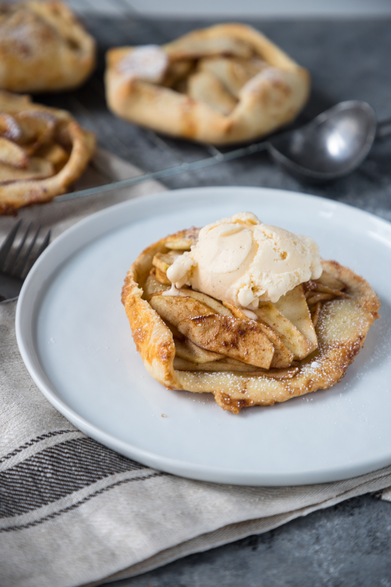 These Apple Galette Mini Tarts are elegantly simple and delightfully rustic. A single-serve dessert perfect for entertaining, this mini dessert includes tender-baked apple with cinnamon, topped on gorgeous, light, and buttery tart shells. Sure to impress the pickiest dessert lovers!