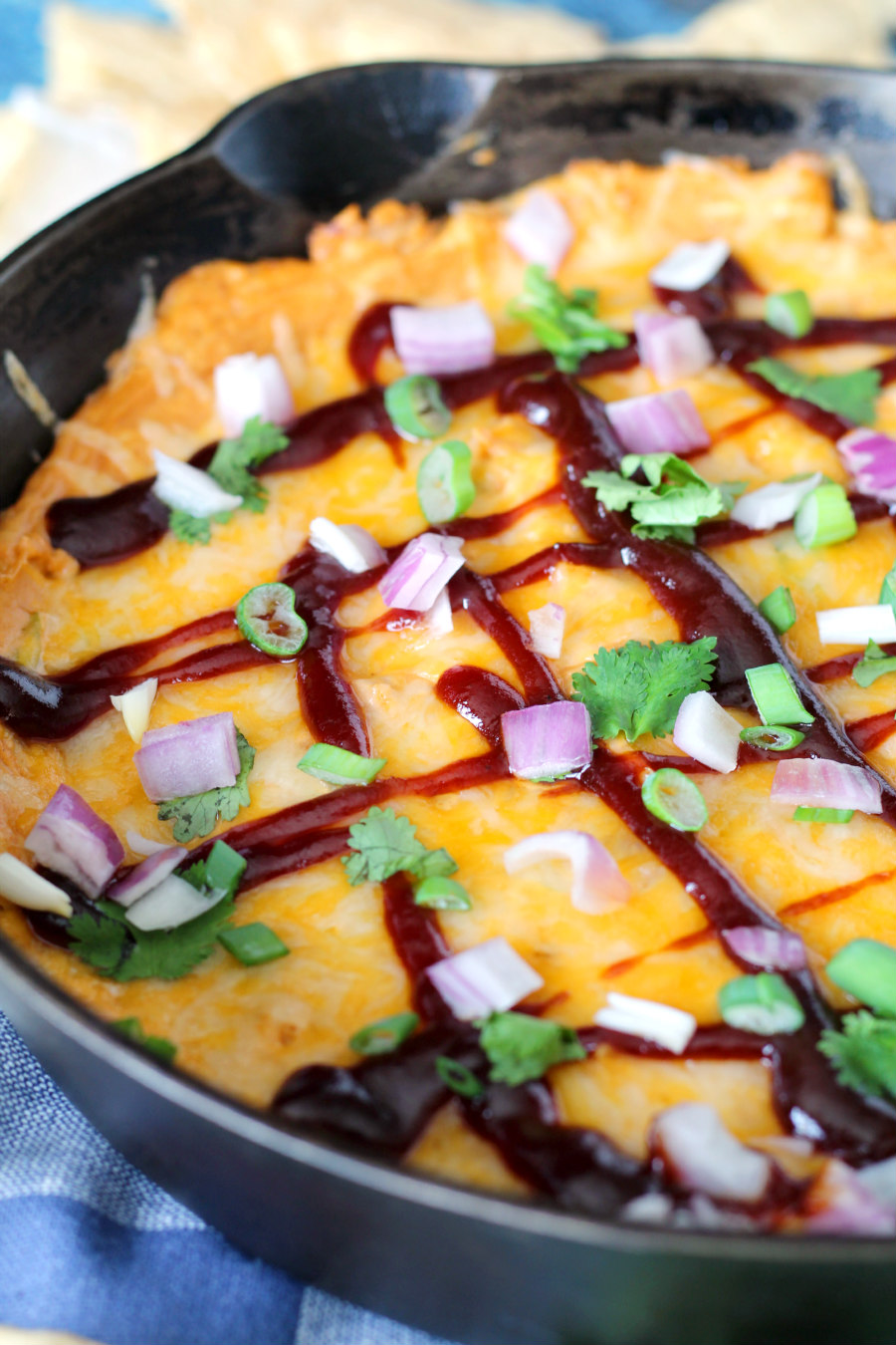 Home entertaining just got more delicious with this simple, loaded BBQ Chicken Skillet Dip. This easy appetizer uses cream cheese, rotisserie chicken, barbecue sauce, green onions, cheddar, and spices to make a hearty dip that holds up to your favorite chips!