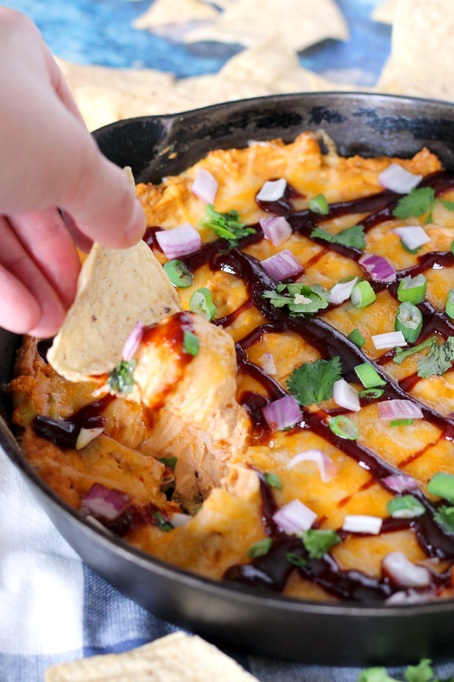 Home entertaining just got more delicious with this simple, loaded BBQ Chicken Skillet Dip. This easy appetizer uses cream cheese, rotisserie chicken, barbecue sauce, green onions, cheddar, and spices to make a hearty dip that holds up to your favorite chips!
