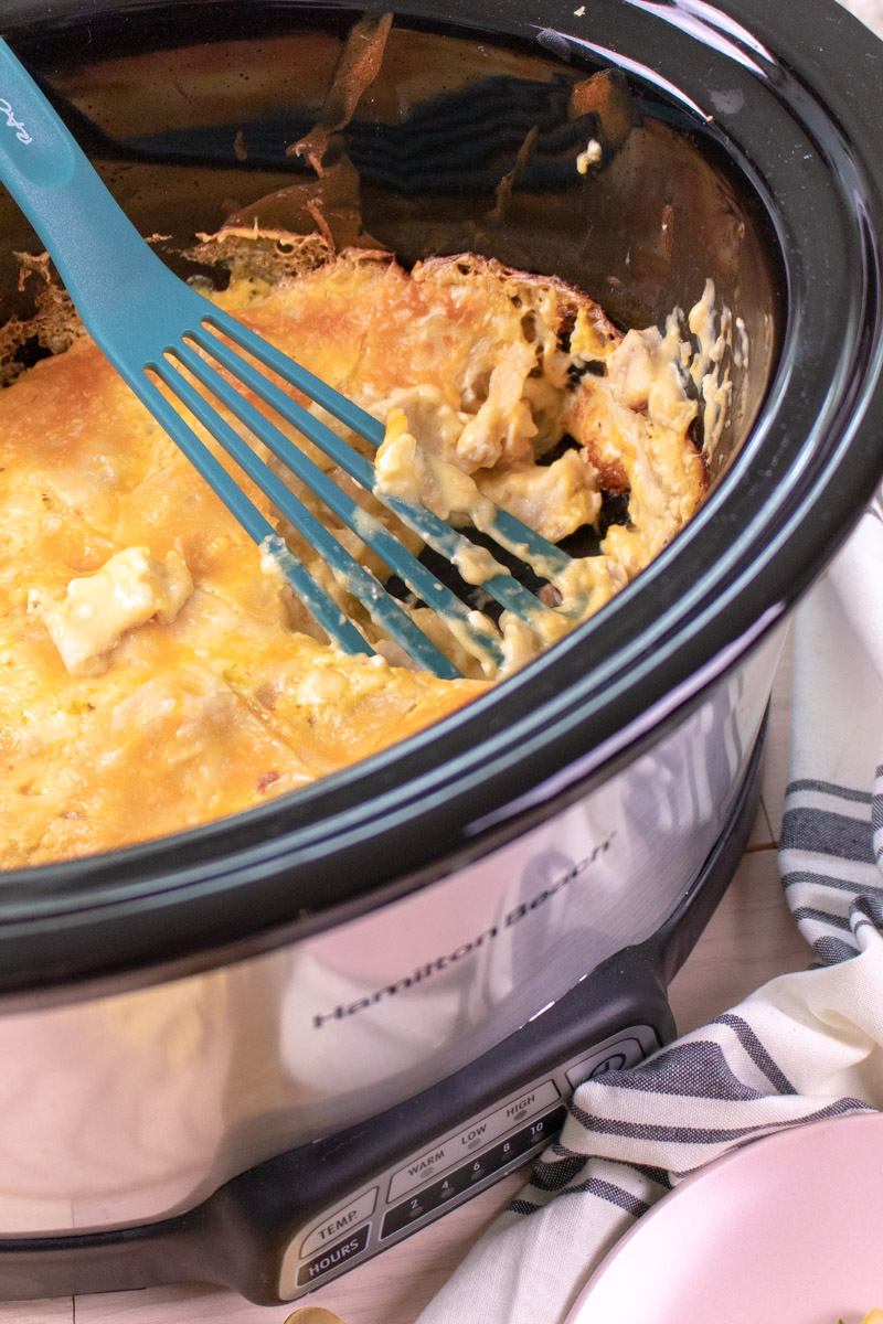 These simple Slow Cooker Chicken Enchiladas are the perfect comfort food for a busy weeknight meal. This dump dinner uses a handful of simple ingredients to slow cook for three hours and mimics a favorite Mexican dish. A one-pot meal with minimal prep and clean up.