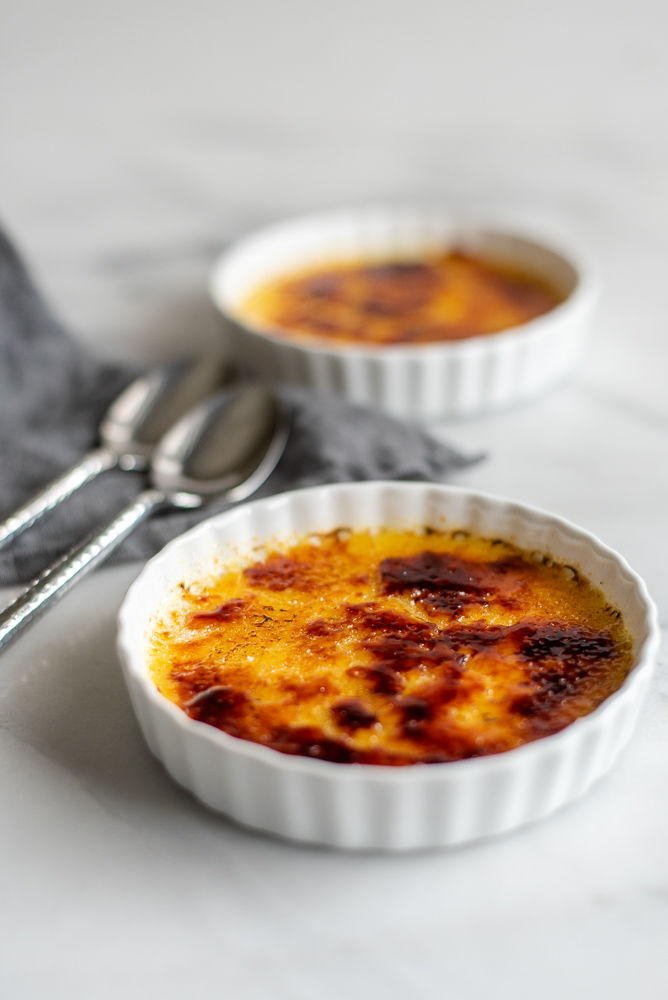 Craving a classic dessert? Bring the taste of French cooking home with this Simple French Creme Brûlée Recipe - a perfect cooking for two dessert. The sweet creamy center and crunch of sugar make this gluten-free mini dessert just irresistible. It's way easier than you'd think!