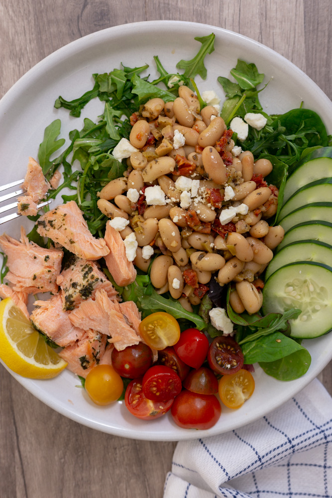 Meal prep this Mediterranean Salmon White Bean Salad - a 30-minute meal - for a satisfying, gluten-free lunch with lean protein and fresh vegetables. This warm salad is Mediterranean Diet approved.