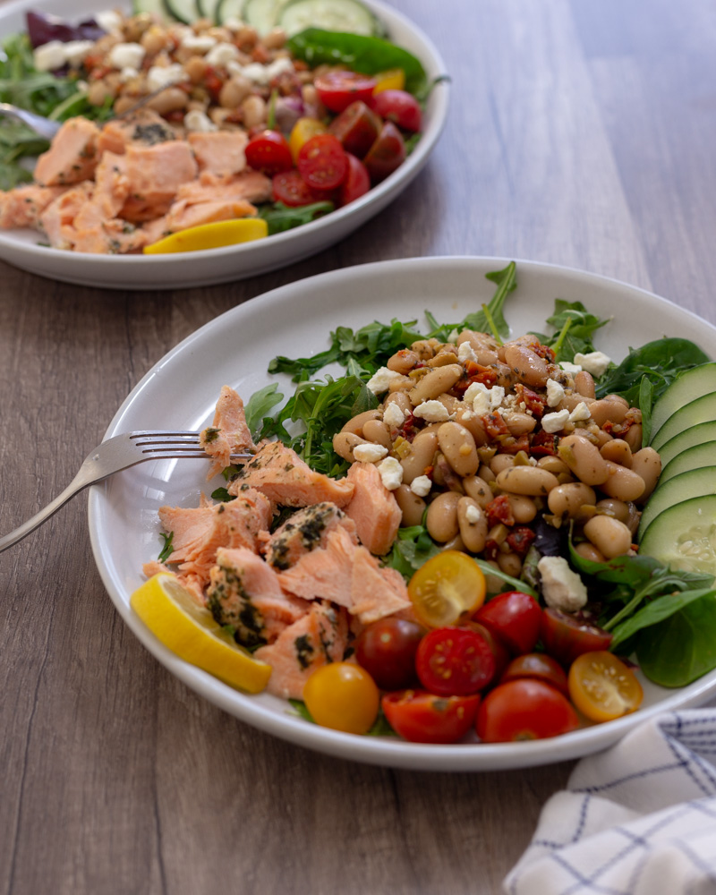 Meal prep this Mediterranean Salmon White Bean Salad - a 30-minute meal - for a satisfying, gluten-free lunch with lean protein and fresh vegetables. This warm salad is Mediterranean Diet approved.