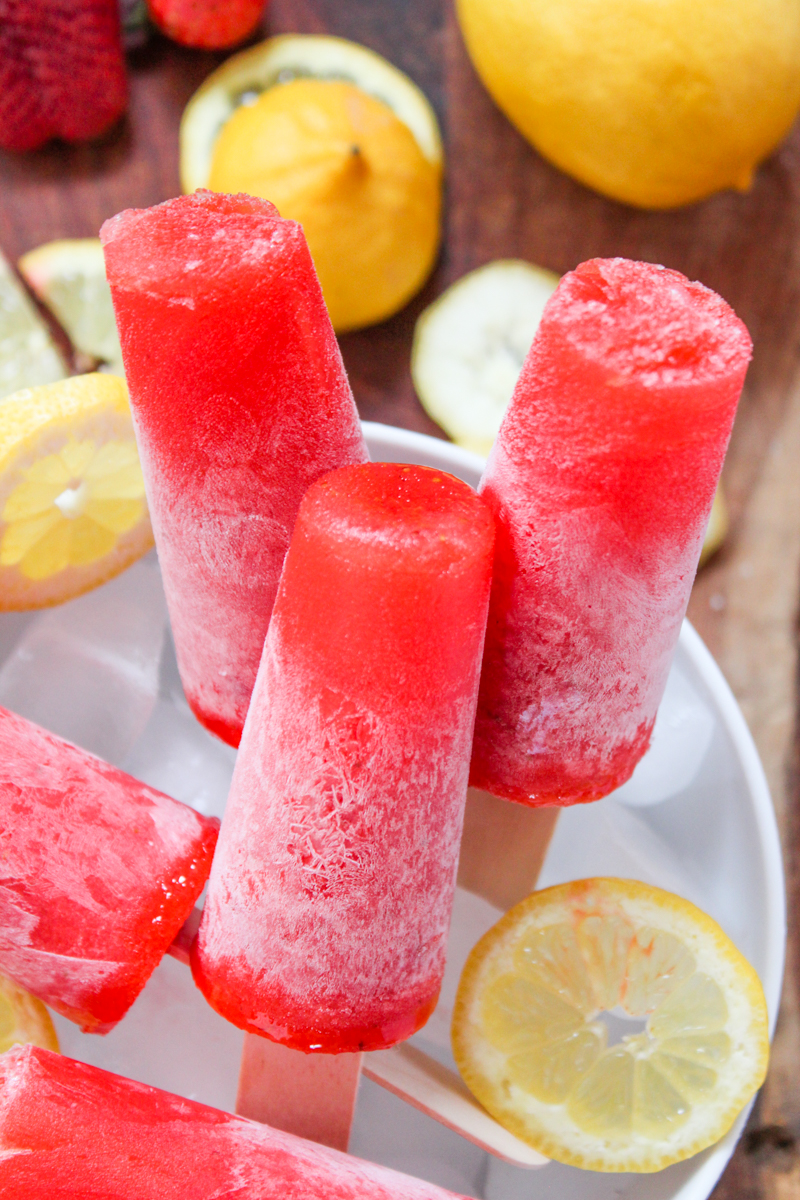Welcome back the sunshine with these 3-ingredient gourmet popsicles for happy hour! These Strawberry Lemonade Daiquiri Popsicles use fresh, farmers market ingredients and rum for an adults-only treat perfect for warm-weather entertaining.