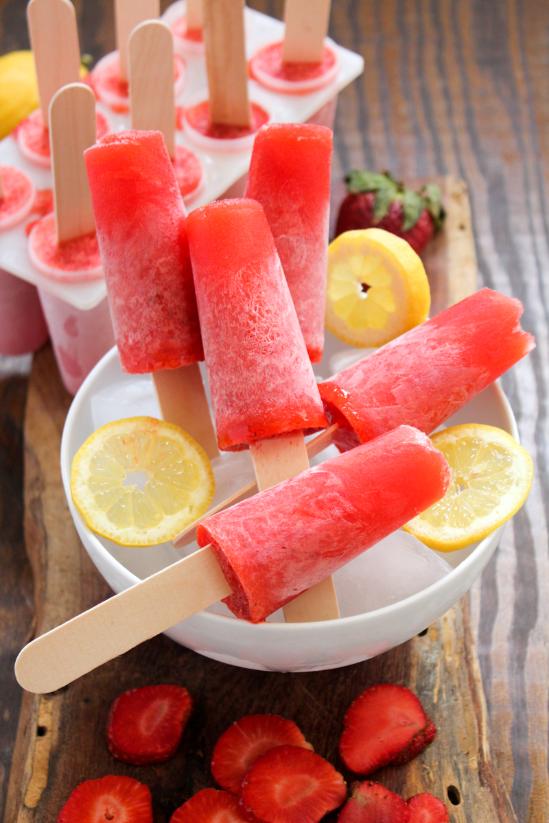 Welcome back the sunshine with these 3-ingredient gourmet popsicles for happy hour! These Strawberry Lemonade Daiquiri Popsicles use fresh, farmers market ingredients and rum for an adults-only treat perfect for warm-weather entertaining.