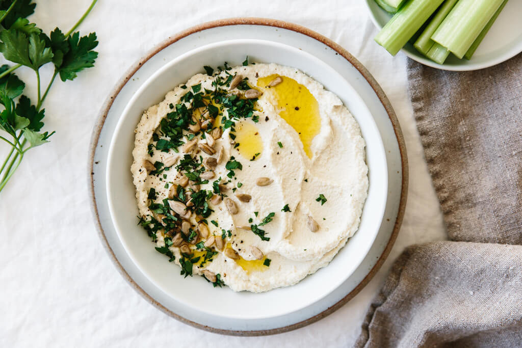 Looking for an easy appetizer that's packed full of healthful ingredients? This Roasted Cauliflower Hummus is a chickpea-free hummus that's low carb, Keto Diet approved, Paleo, and Whole30 friendly!
