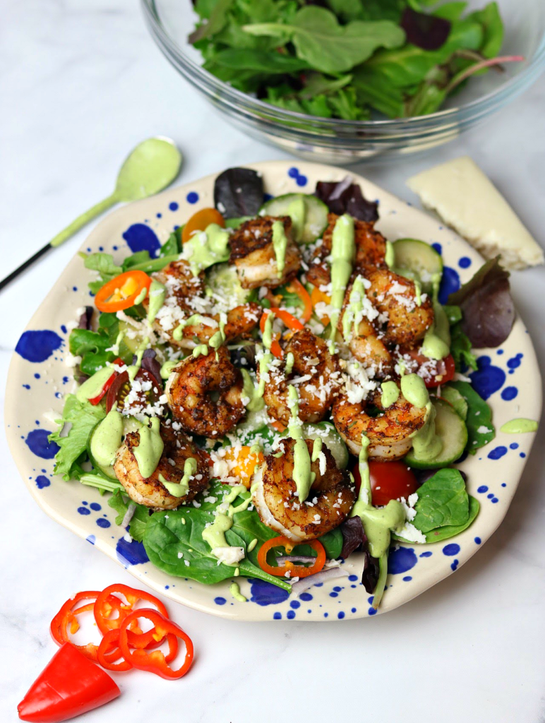 This Mexican Whole30 Shrimp Salad is a 15-minute meal that's Keto Diet approved. Shrimp, Cojita cheese, avocado lime dressing, and layers of fresh farmers market veggies including spring mix, red onions, bell peppers, and heirloom tomatoes.