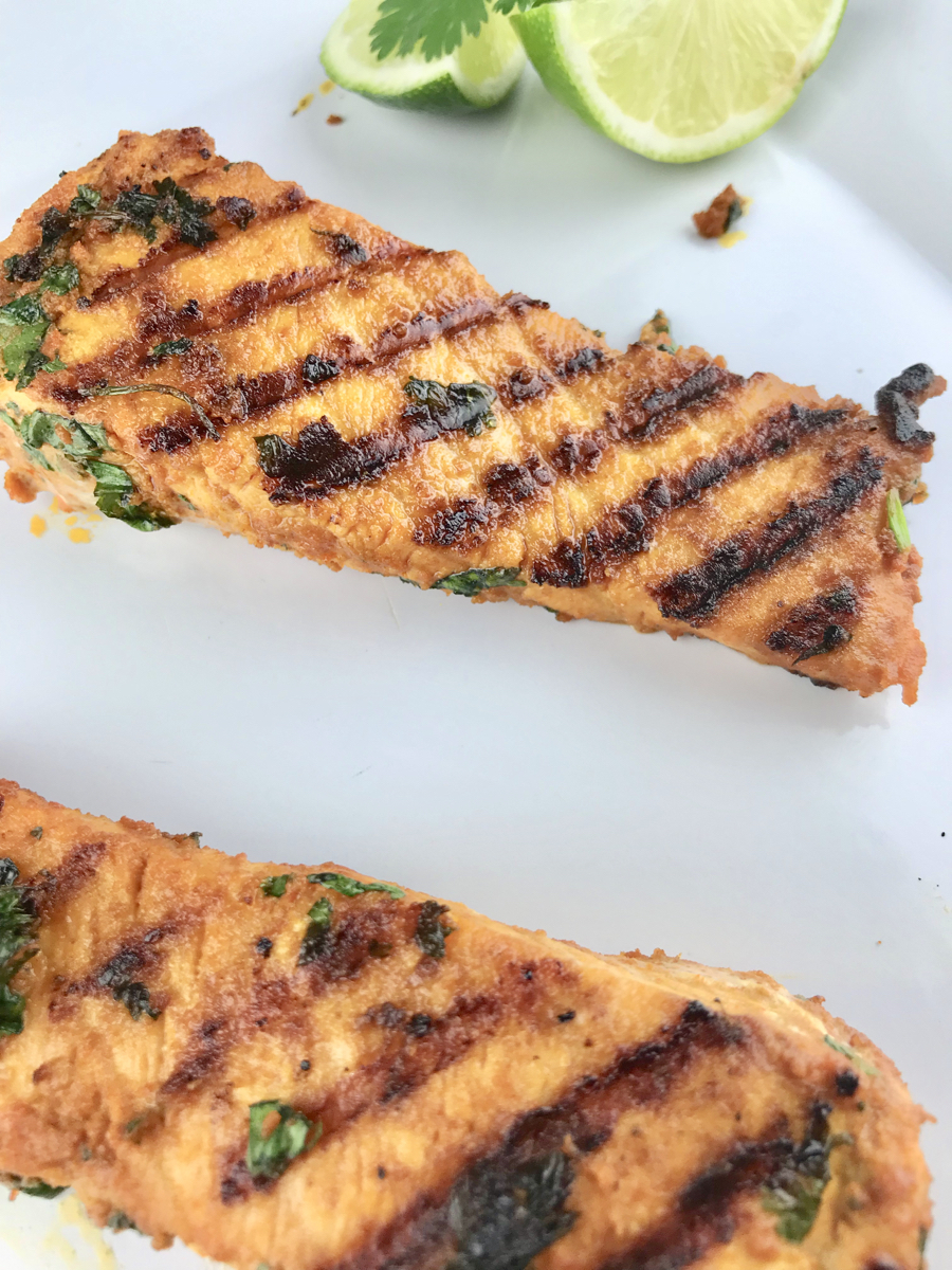 Grilled Spicy Cilantro Lime Salmon is a 30-minute meal perfect for a weeknight dinner. Served with cauliflower rice and grilled veggies, this grilled salmon is Keto Diet friendly. Outdoor grilling never tasted so good!