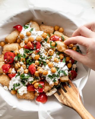 These lower carb Loaded Mediterranean Veggie Tots use cauliflower tots instead of potato tots. A 20-minute vegetarian dish covered in feta, herbs, roasted chickpeas, and creamy tzatziki using frozen veggie tots!