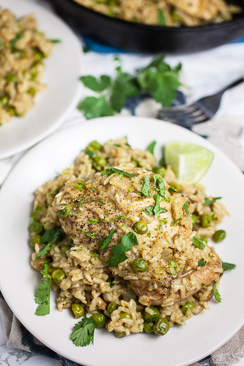 This Skillet Coconut Chicken and Rice is the perfect easy cast iron skillet dinner! It's got juicy chicken thighs, fragrant rice, and fresh herbs. A one-pan meal the whole family will love!