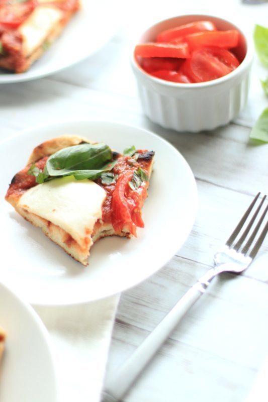 This easy grilled pizza recipe takes just 15 minutes. Whether you decide to grill a Caprese Pizza or a meatier variety, grilled pizza takes outdoor grilling to a new level. The homemade pizza dough really makes the meal!