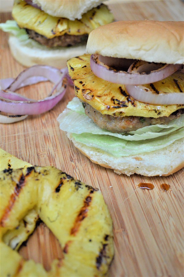 These Grilled Pineapple Teriyaki Turkey Burgers with grilled onions take outdoor grilling to a new level! Grilled turkey burgers are a low-fat option to traditional grilled burgers and the sweet and tangy taste of these will leave you drooling!