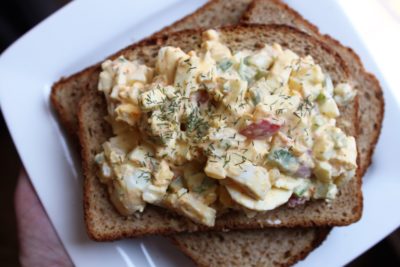 Looking for a budget meal that everyone will love? This Loaded Egg Salad is a deli-style meal that's the perfect picnic food! Ready in 30 minutes, this comfort food is loaded with eggs, celery, and surprise ingredients that give it a crunch and flavor like no traditional egg salad you've ever tried!