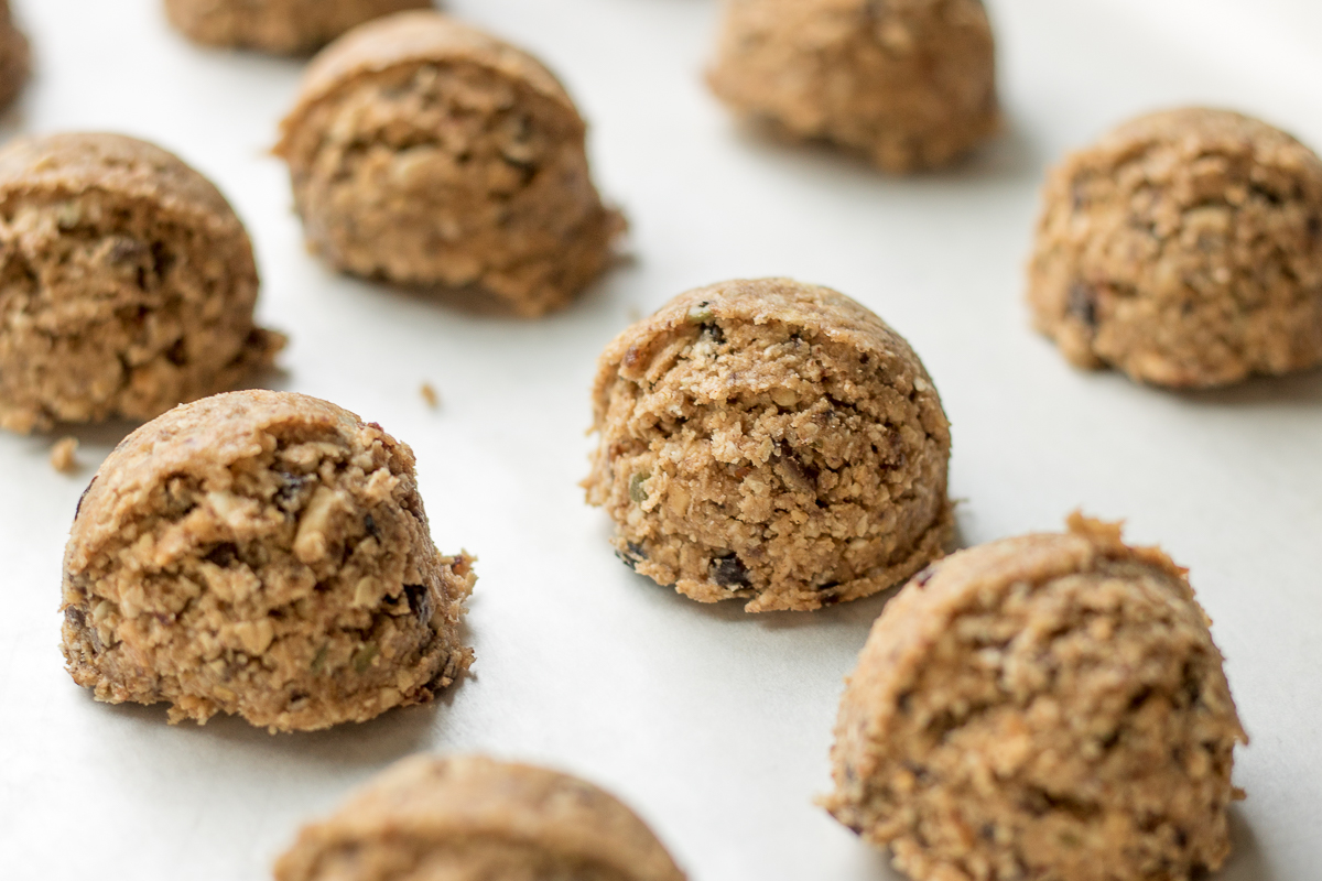 Almond Butter Oatmeal Energy Bites are a protein-packed, healthy snack combining your favorite trail mix, quick oats, protein powder, almond butter, maple syrup, honey, and chocolate.