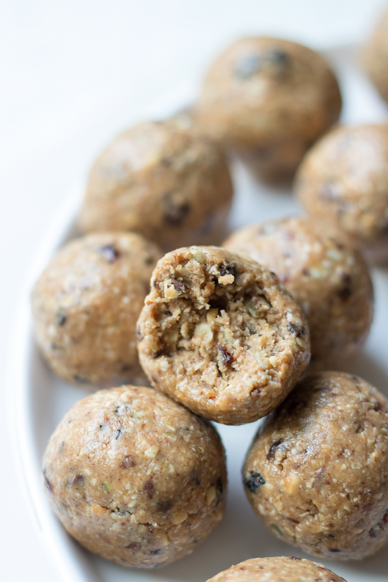 Almond Butter Oatmeal Energy Bites are a protein-packed, healthy snack combining your favorite trail mix, quick oats, protein powder, almond butter, maple syrup, honey, and chocolate.