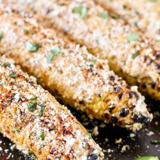 Fresh ears of corn are grilled until browned and smoky then coated in a mixture of sour cream, mayo, chili powder, and cotija cheese. Topped with fresh lime juice, this Grilled Mexican Street Corn is the perfect version of Mexican Elote!