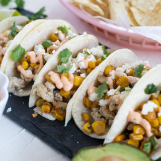 Enjoy the flavors of Mexican Elote with these simple Mexican Street Corn Chicken Tacos instead of traditional tacos. Roasted corn, spicy mayo dressing, lime juice, and your favorite taco toppings for the perfect weeknight meal.