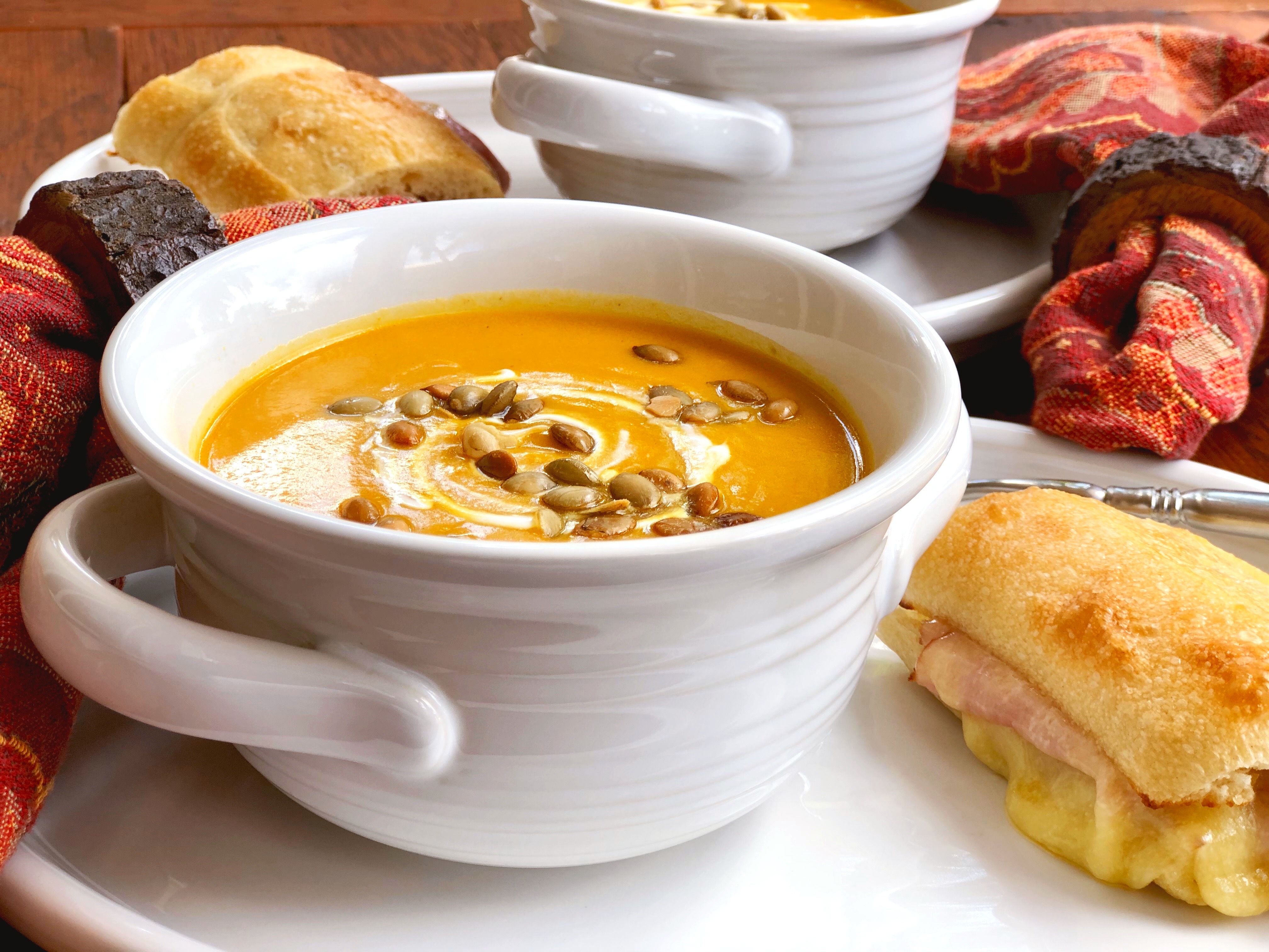 Cozy up on a chilly evening with this homemade Pumpkin Soup with Gruyere Grilled Cheese Ham Sandwich. This simple deli-style meal is the perfect comfort food for lunch or dinner.