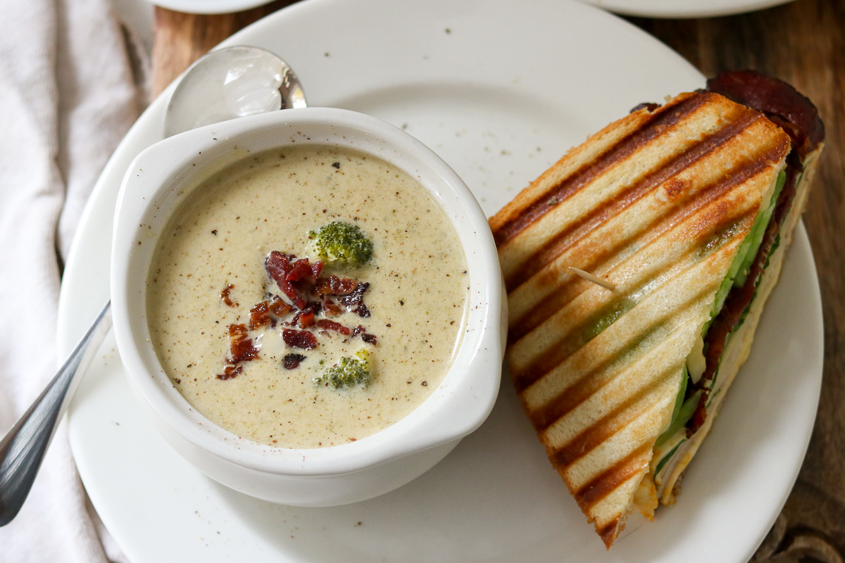 Enjoy a budget-friendly deli-style meal with this Broccoli Cheese Soup and Hot Turkey Club Panini combo. Creamy cheddar cheese soup with broccoli paired with a crunchy turkey panini with tomatoes, cheese, beef bacon, and crisp Romaine.