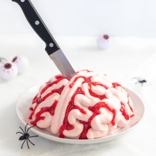 Whether you need a Halloween dessert or a spooky-themed party cake, this Zombie Brain Cake is perfect! Dark chocolate cake with vanilla frosting and bloody effects is the ultimate party food!