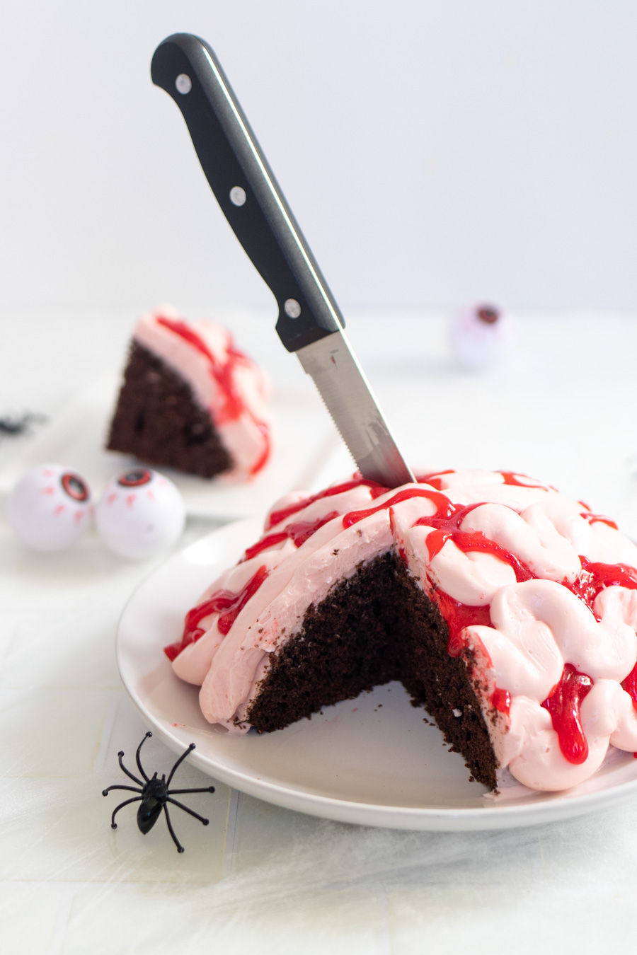 Whether you need a Halloween dessert or a spooky-themed party cake, this Zombie Brain Cake is perfect! Dark chocolate cake with vanilla frosting and bloody effects is the ultimate party food!