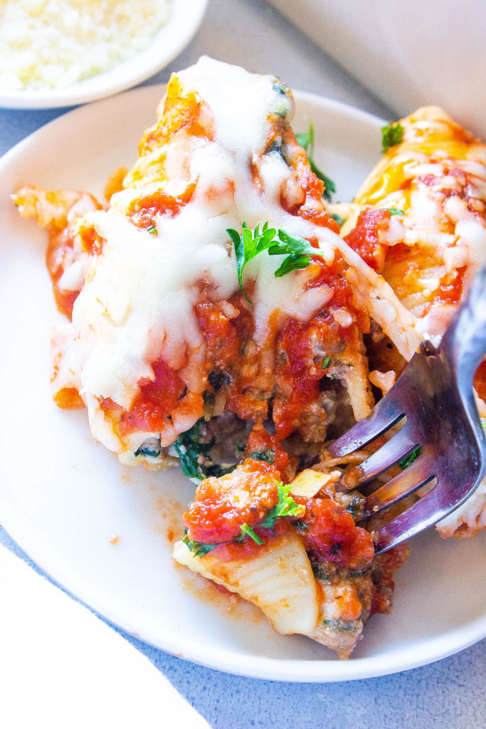 These Beef Lasagna Stuffed Shells are a budget-friendly meal. This simple dinner alternative to classic lasagna uses jumbo pasta shells stuffed with a beefy mozzarella and ricotta cheese filling that are baked in the oven for 45 minutes. 