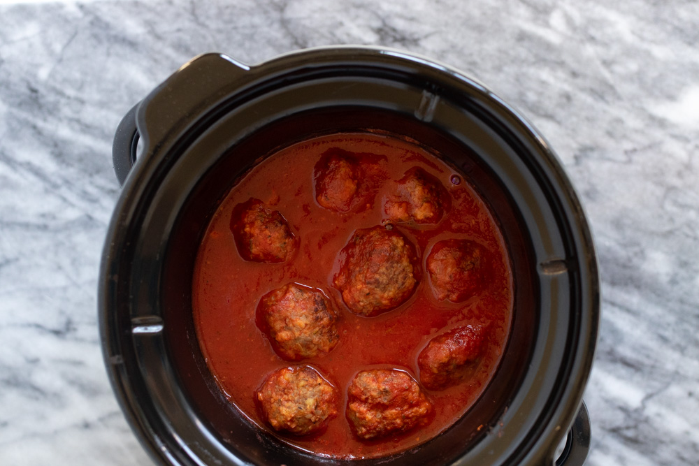 These Slow Cooker Italian Sausage Meatballs smothered in marinara sauce can be served as a party appetizer right out of the Crock Pot, alongside your favorite pasta dish, or in sliders with a sprinkle of Parmesan.