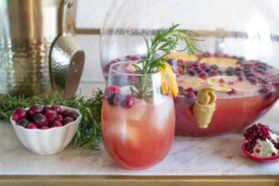 Savor seasonal flavors and ring in the new year with this Spiked Seltzer Holiday Punch! This rum-based cocktail combines trendy spiked seltzer with cranberry juice and orange juice. Garnish with fresh pomegranate seeds and citrus for a festive flair!